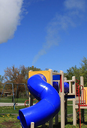 Children's playground in front of a power plant.