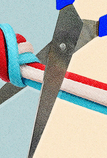 Someone cutting a rope of red, white and blue strings with scissors