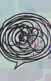 Illustration of a speech bubble with scribbles inside, background of more speech bubbles colored purple and blue, with floating letters scattered in the background