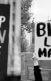 Black and white photos of a stop Asian hate sign and a black lives matter sign, both images taken a protest events