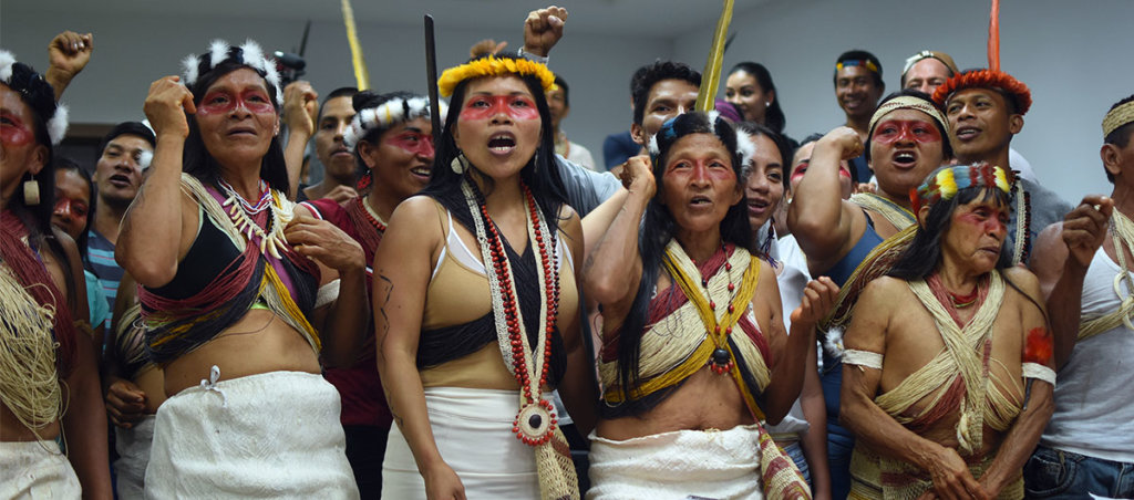 A photo of a group of Indigenous women in traditional outfits