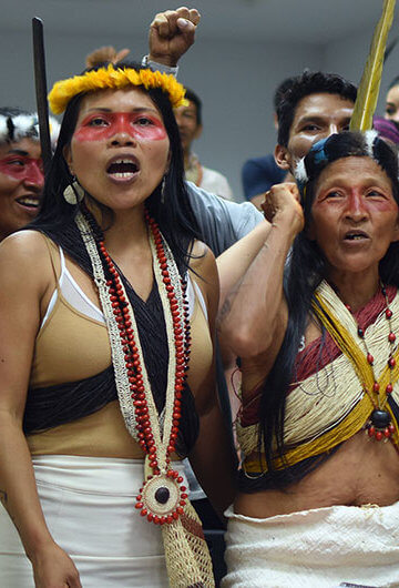 A photo of a group of Indigenous women in traditional outfits