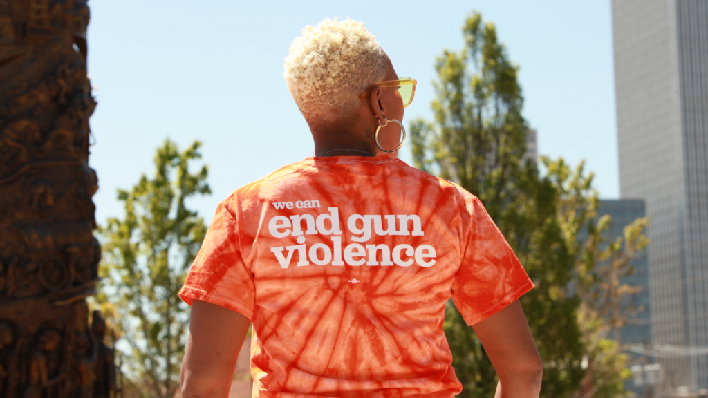 Woman with back to camera wearing an End Gun Violence t-shirt