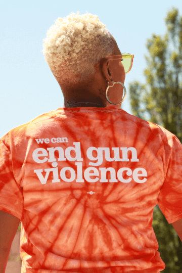 Woman with back to camera wearing an End Gun Violence t-shirt