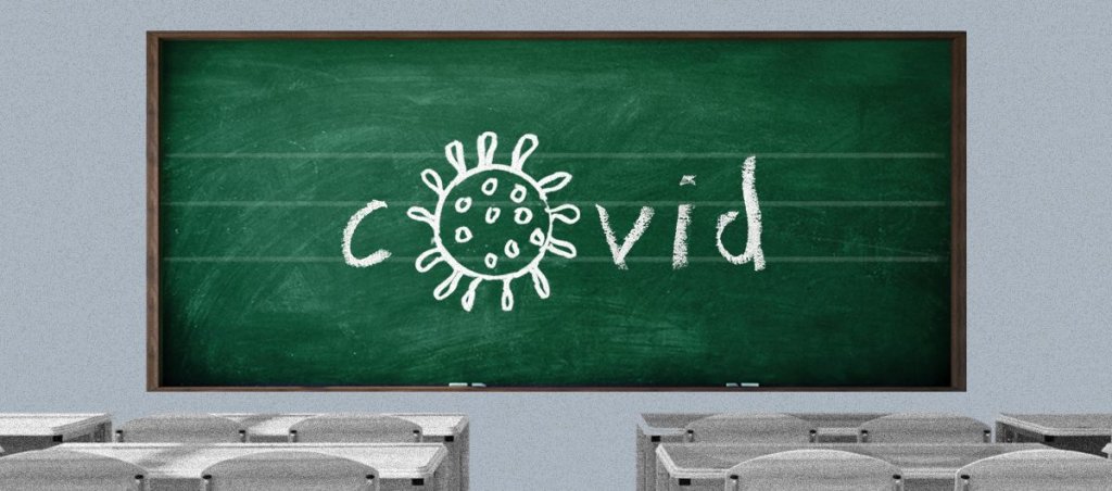 a classroom blackboard with covid spelled out but the o is in the shape of the covid virus