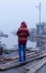 person standing amongst debrief from a tornado or hurricaine