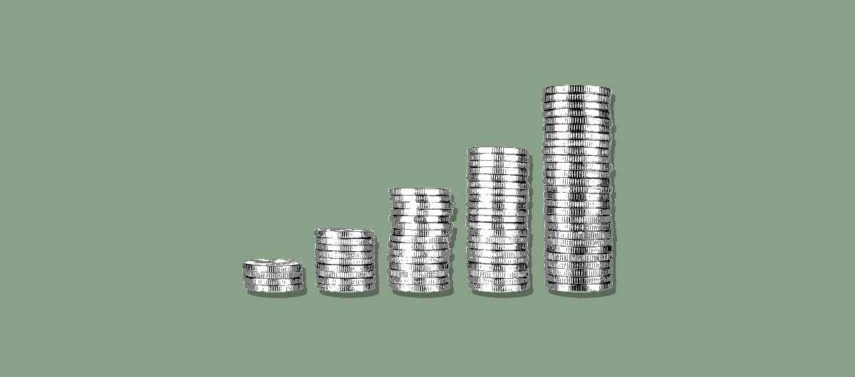 stacks of ascending coins on a green background