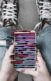 a teen girls legs with her hands resting on her knees looking at a smart phone