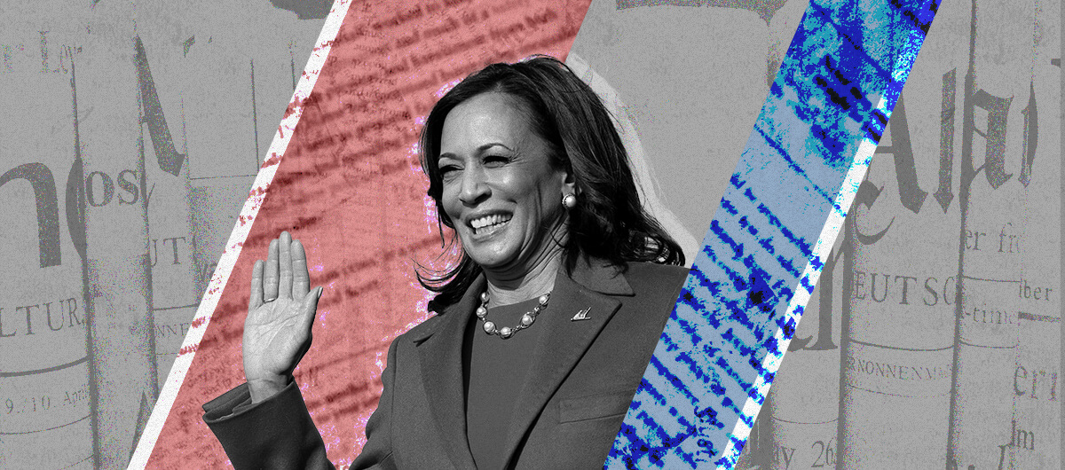Vice President Kamala Harris at her swearing in, smiling and raising her hand. In the background of the photo is newsprint