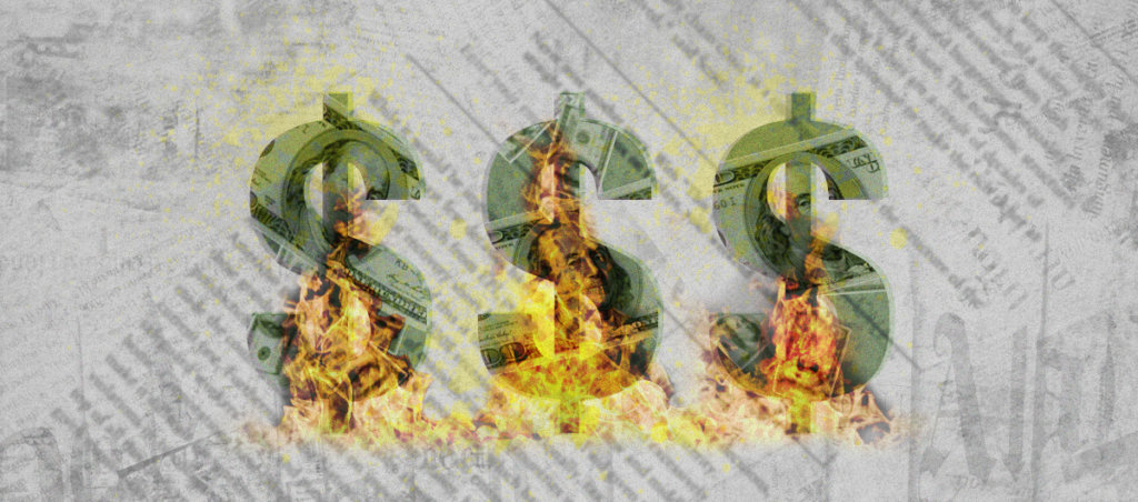 three dollar signs on fire with newsprint in the background