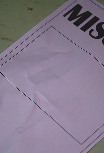 a missing persons poster on a greenish background.