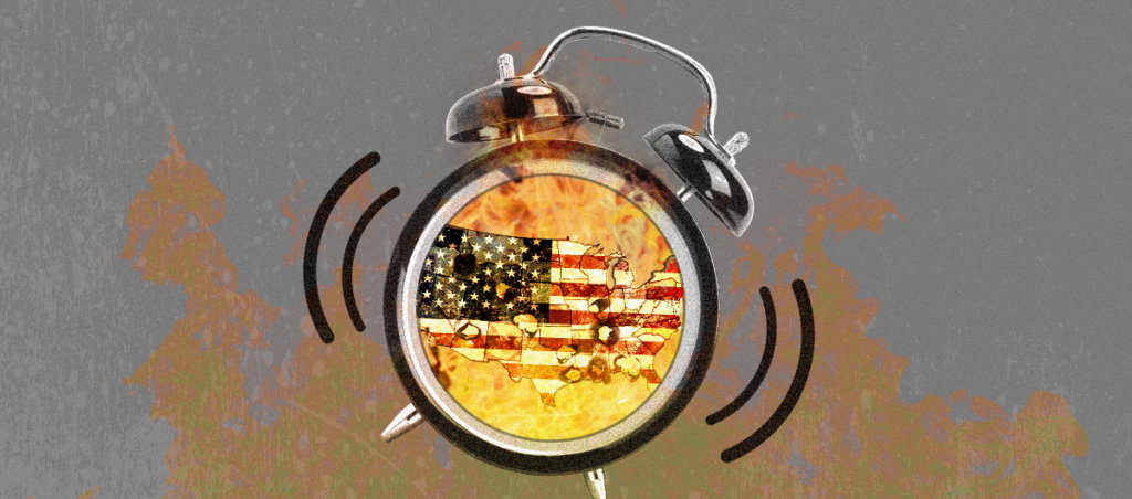 an alarm clock with the american flag inside it. there are flames behind it