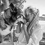 A profile image of Jennifer Reitman turning towards her dog.