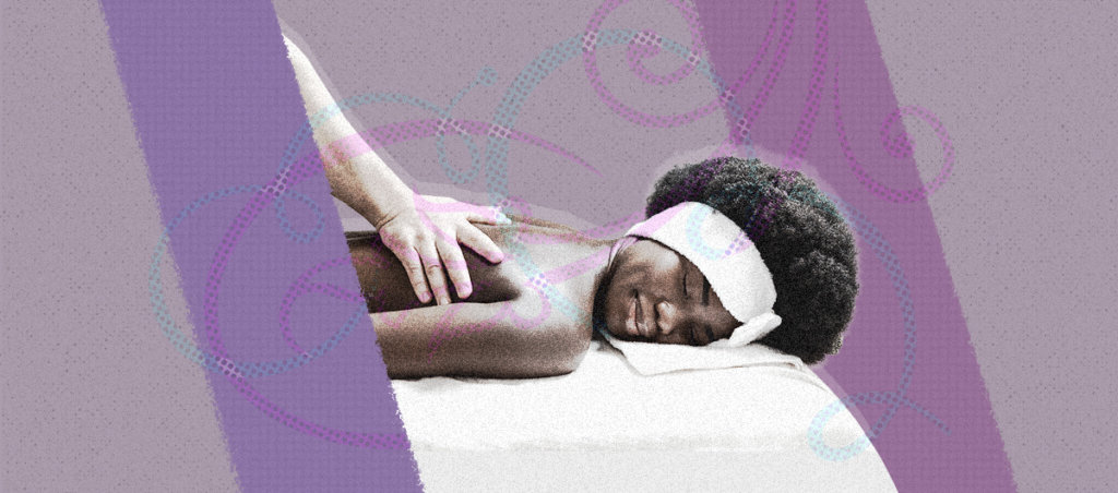 A Black woman, on a massage table, getting a massage. She has a blissful expression on her face.