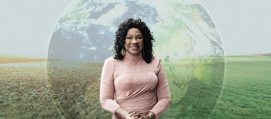 A photo of Dr. Beverly Wright, a Black woman, in front of a transparent image of the Earth globe, with two fields in the background.