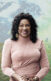 A photo of Dr. Beverly Wright, a Black woman, in front of a transparent image of the Earth globe, with two fields in the background.