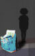 A silhouette of a kid in the background with a backpack stuffed with school supplies in the front