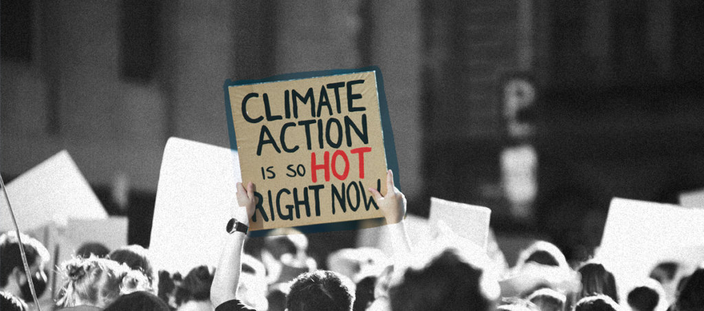 Photo of people protesting, but people's faces are turned the other way. Someone is holding up a sign that says "Climate action is so, so hot right now."