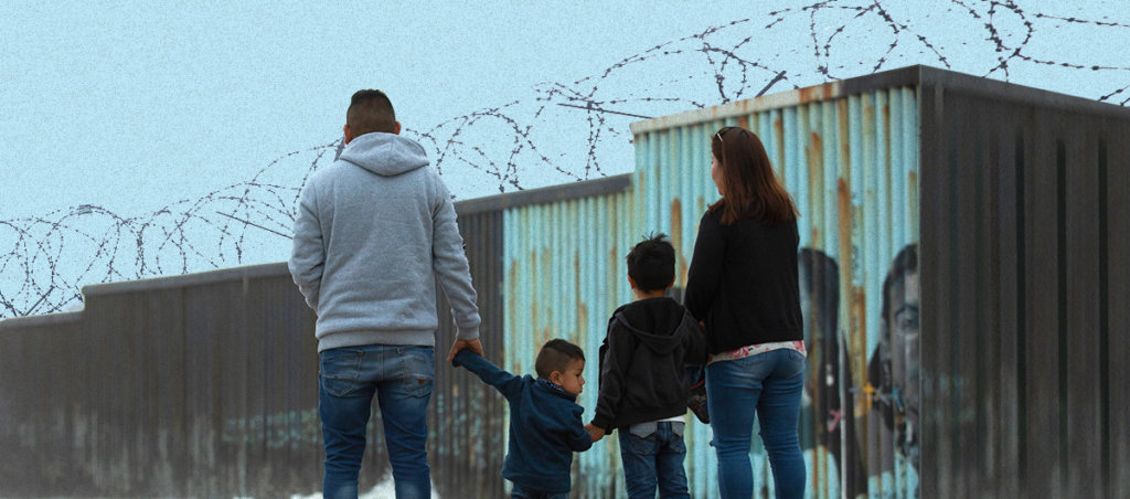 Four Latino people – a father, a mother and two children – walking. They are facing away from the camera.