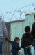 Four Latino people – a father, a mother and two children – walking. They are facing away from the camera.