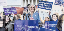 A photo from an anti-abortion protest, and mainly white women are visibly protesting with signs with messages like "Pro-Life for the whole life."