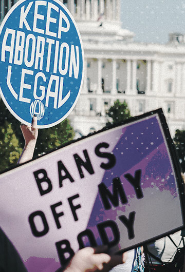 A photo from a protest with signs that say, "Keep Abortion Legal" and "Bans Off My Body." Illustrations of the central image are on the left and right.