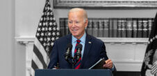 An image of President Joe Biden standing behind a podium at the White House