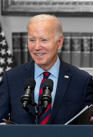 An image of President Joe Biden standing behind a podium at the White House