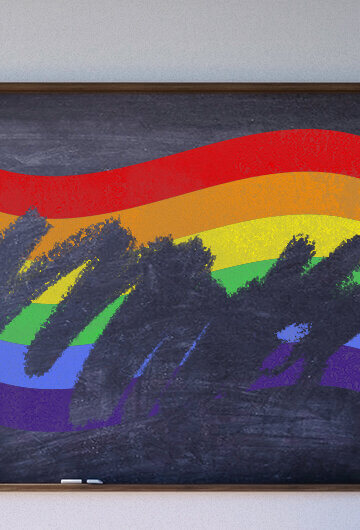 Image of a LGBTQ flag on a school blackboard. The flag is being erased as if it were drawn in chalk.